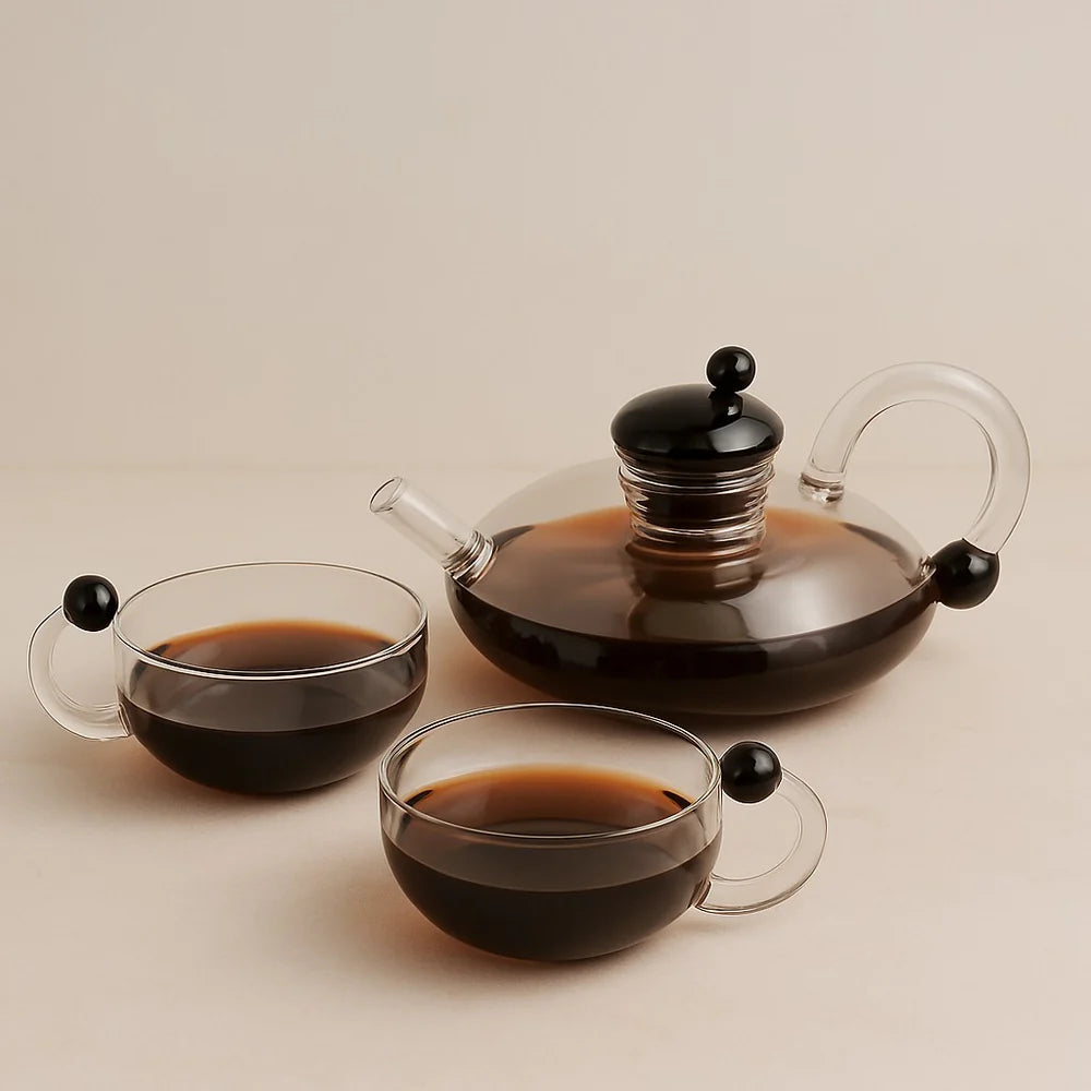Sereno glass teapot set with semi-automatic filtration system on wooden table