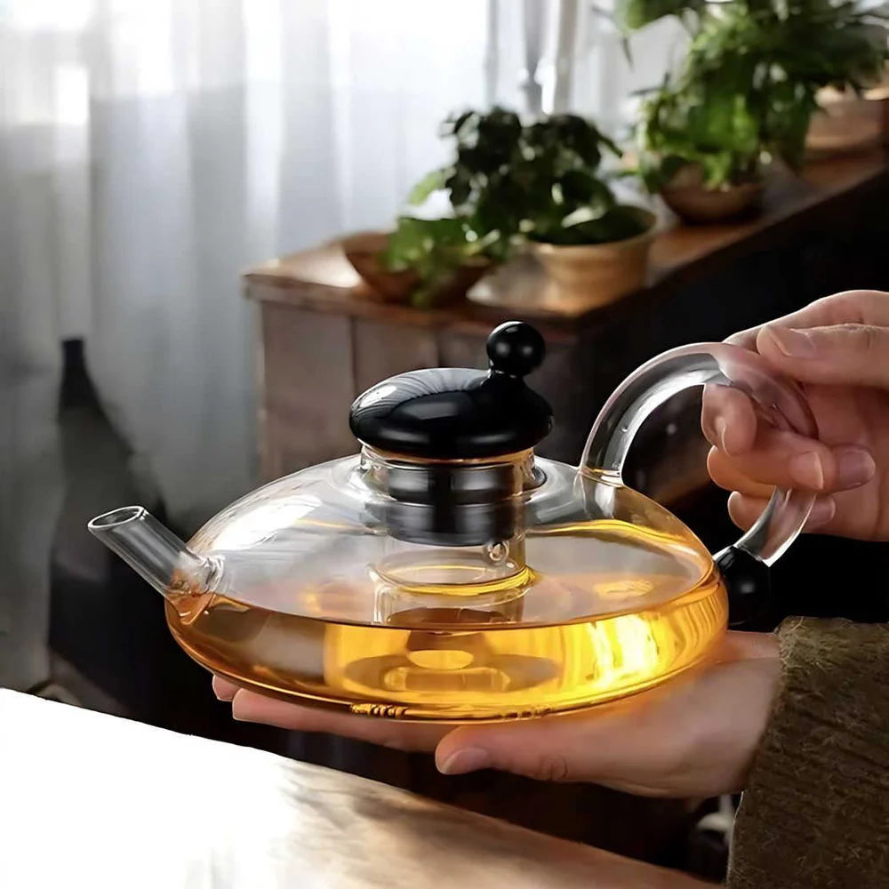 Sereno teapot set shown with blooming tea leaves inside transparent glass body
